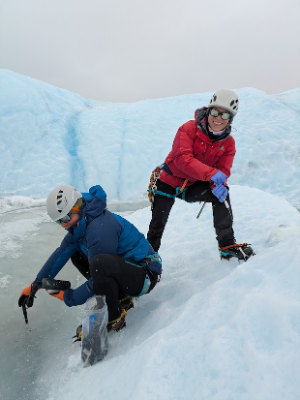 Jane and Leah collecting samples from the first meltwater on the surface of the ice